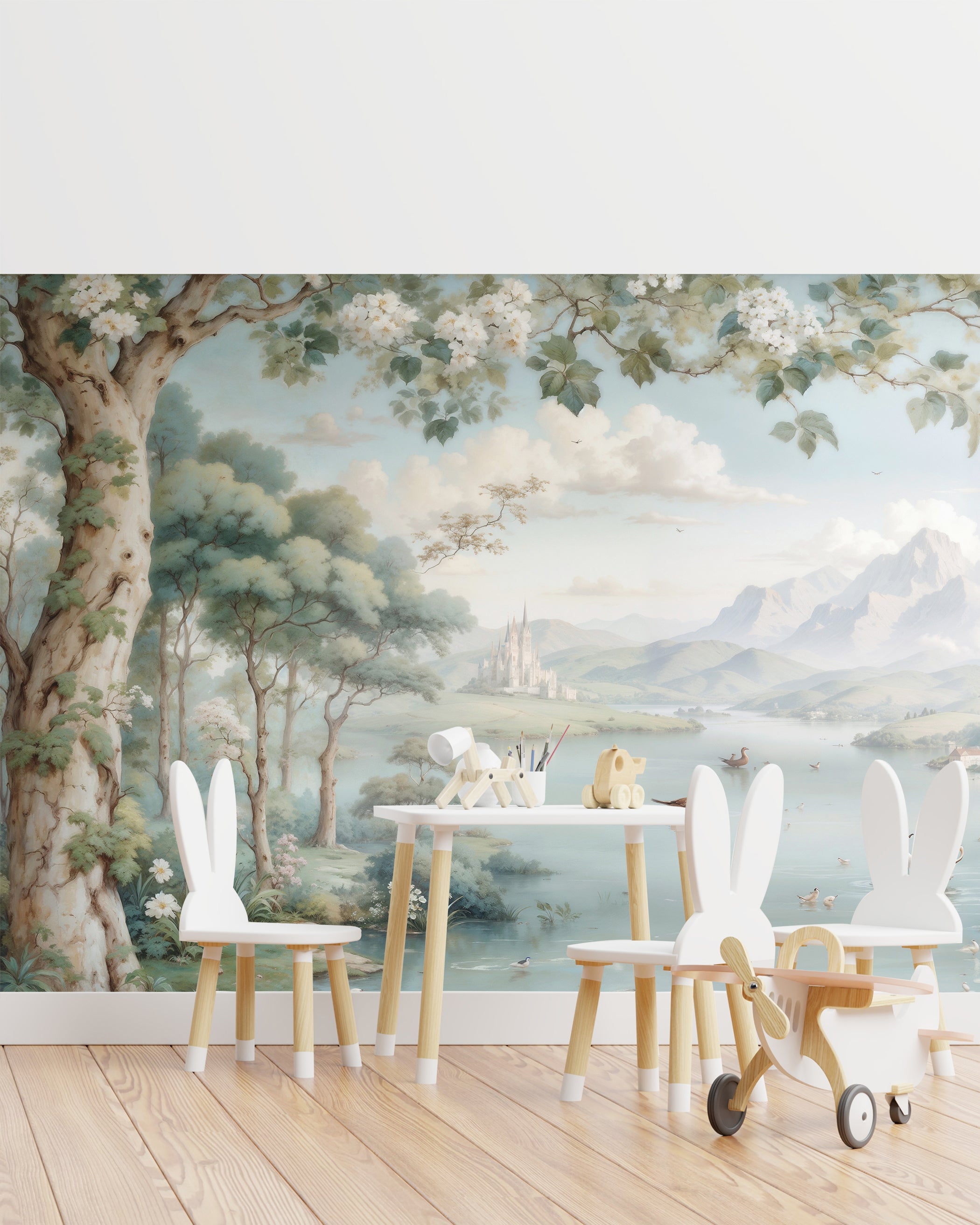 "Play area for children with Chamonix Valley mural as the backdrop, depicting lush trees, a calm lake, and a fairy-tale castle in the distance