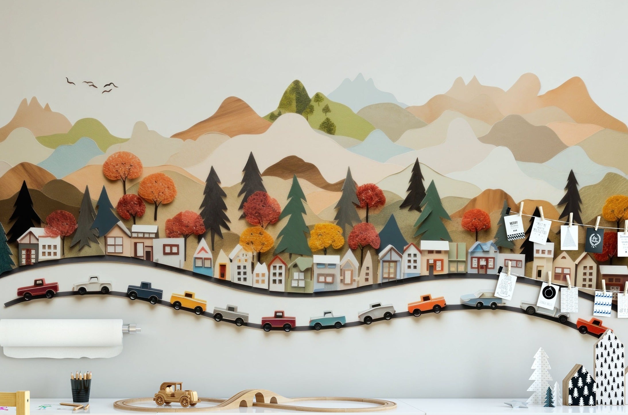 Child's playroom featuring a 'Craft Car Mural' with a scenic village, colorful trees, and toy cars on a winding road across rolling hills.