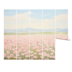 "Meadow Dreaming wallpaper mural featuring soft pink blossoms and distant mountain views."