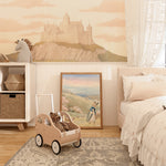 Play area in a child's room with a pastel castle mural backdrop, featuring wooden toys and playful décor.