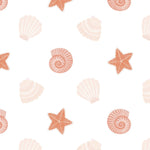 Detailed view of the Mermaid Shells Wallpaper showcasing an array of seashells and starfish in a repeating pattern. The soft orange and pink hues on a light background provide a gentle, beachy aesthetic suitable for various interiors.