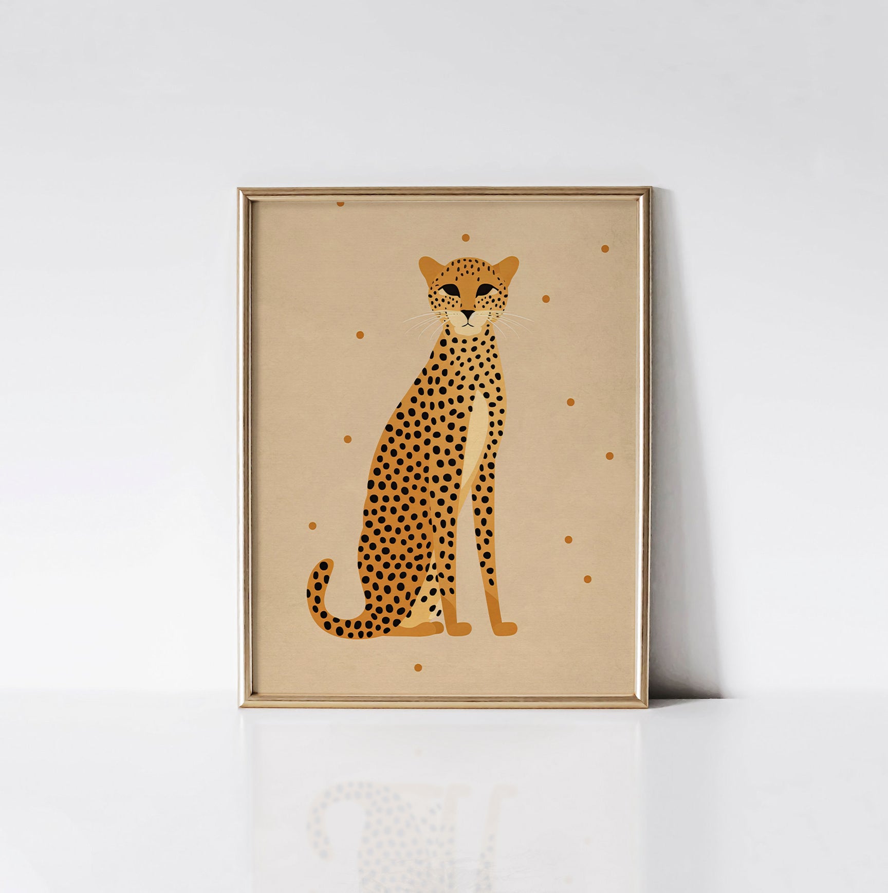 Minimalist Leopard Elegance art print displayed in a sleek gold frame, featuring a poised leopard on a soft beige background with delicate dots.
