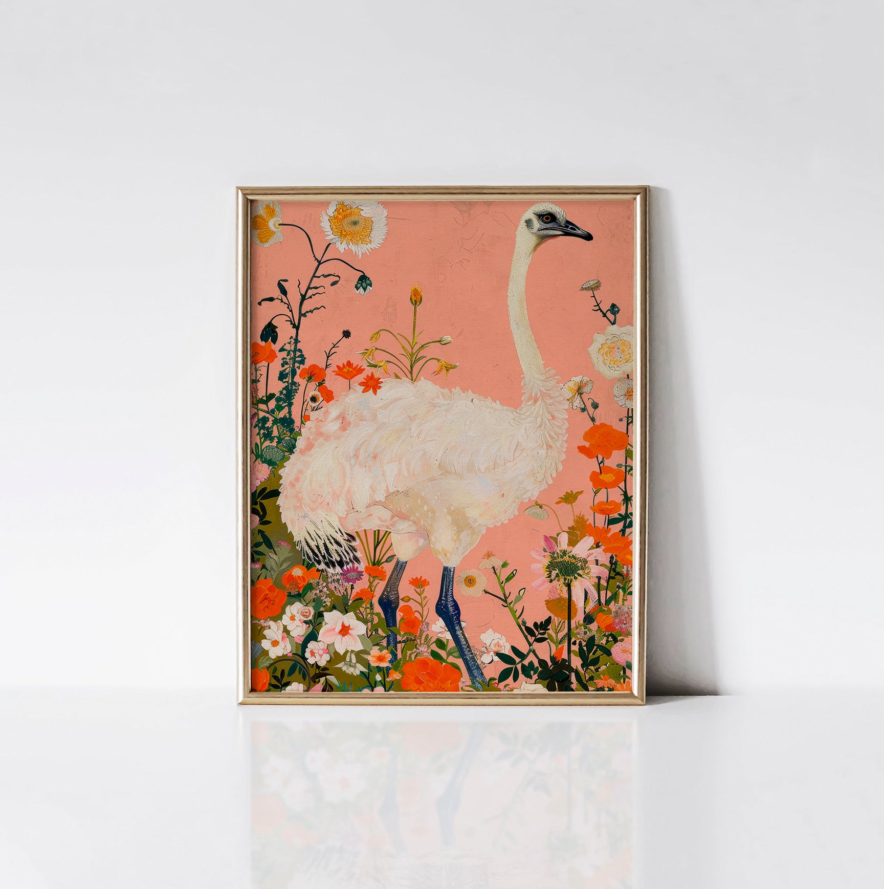 Ethereal Ostrich Garden Art Print framed in an elegant gold frame, showcasing an ostrich with white feathers among colorful flowers on a peach background.