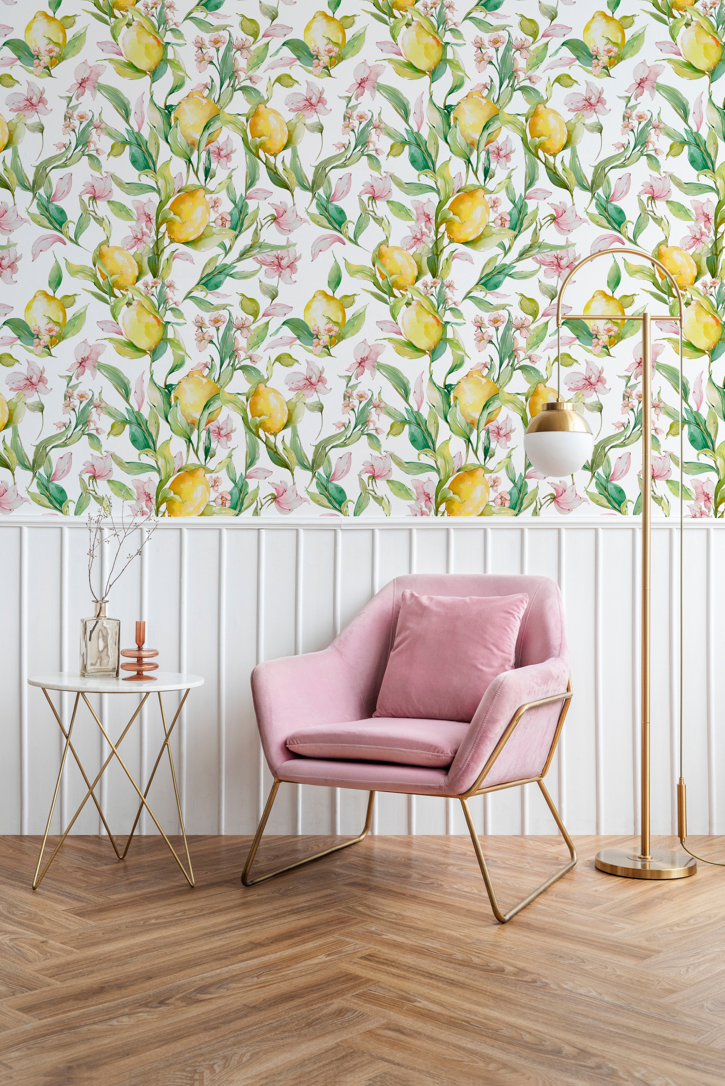 Contemporary living space accented with Citrus Blossom Wallpaper, which infuses the room with a burst of nature-inspired beauty. The wallpaper features yellow lemons and pink blossoms, complementing the modern pink armchair and golden decor elements, adding sophistication and warmth