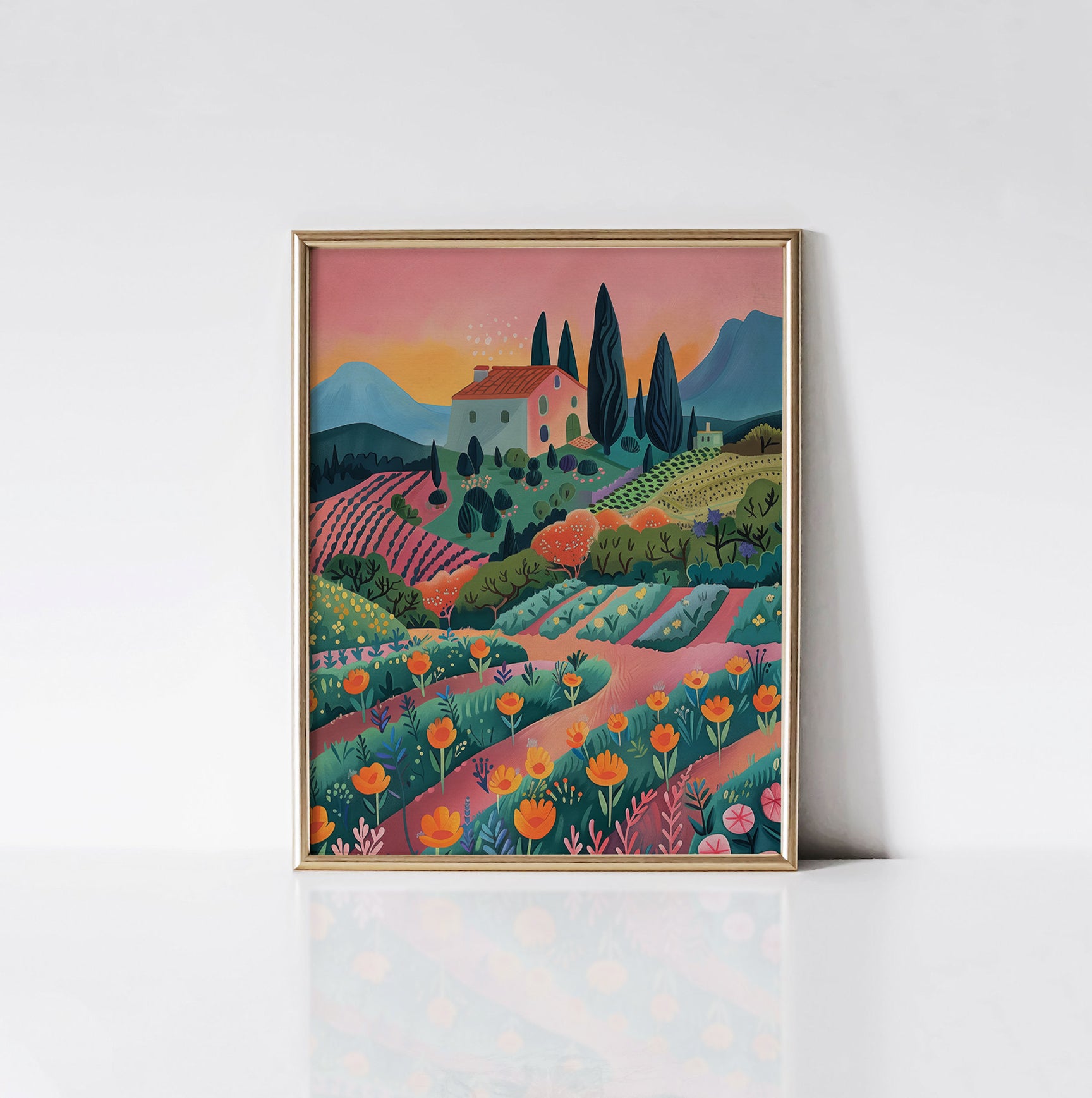 Sunset Vineyard art print displayed in a sleek gold frame, featuring a picturesque vineyard at sunset with colorful flowers and a quaint farmhouse