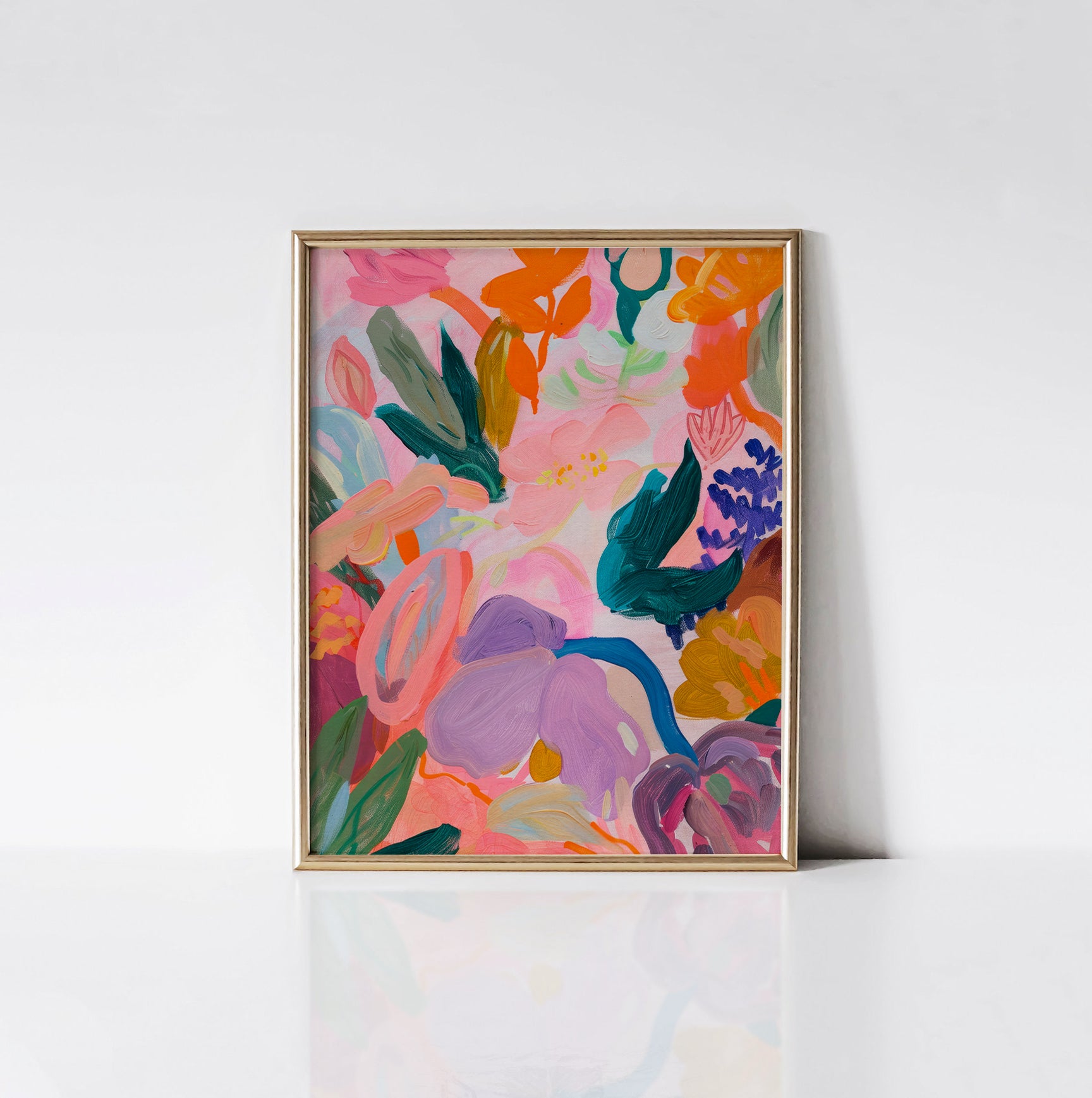 Abstract Floral Harmony Art Print framed in an elegant gold frame, showcasing a dynamic blend of colorful abstract flowers in pink, orange, green, and purple