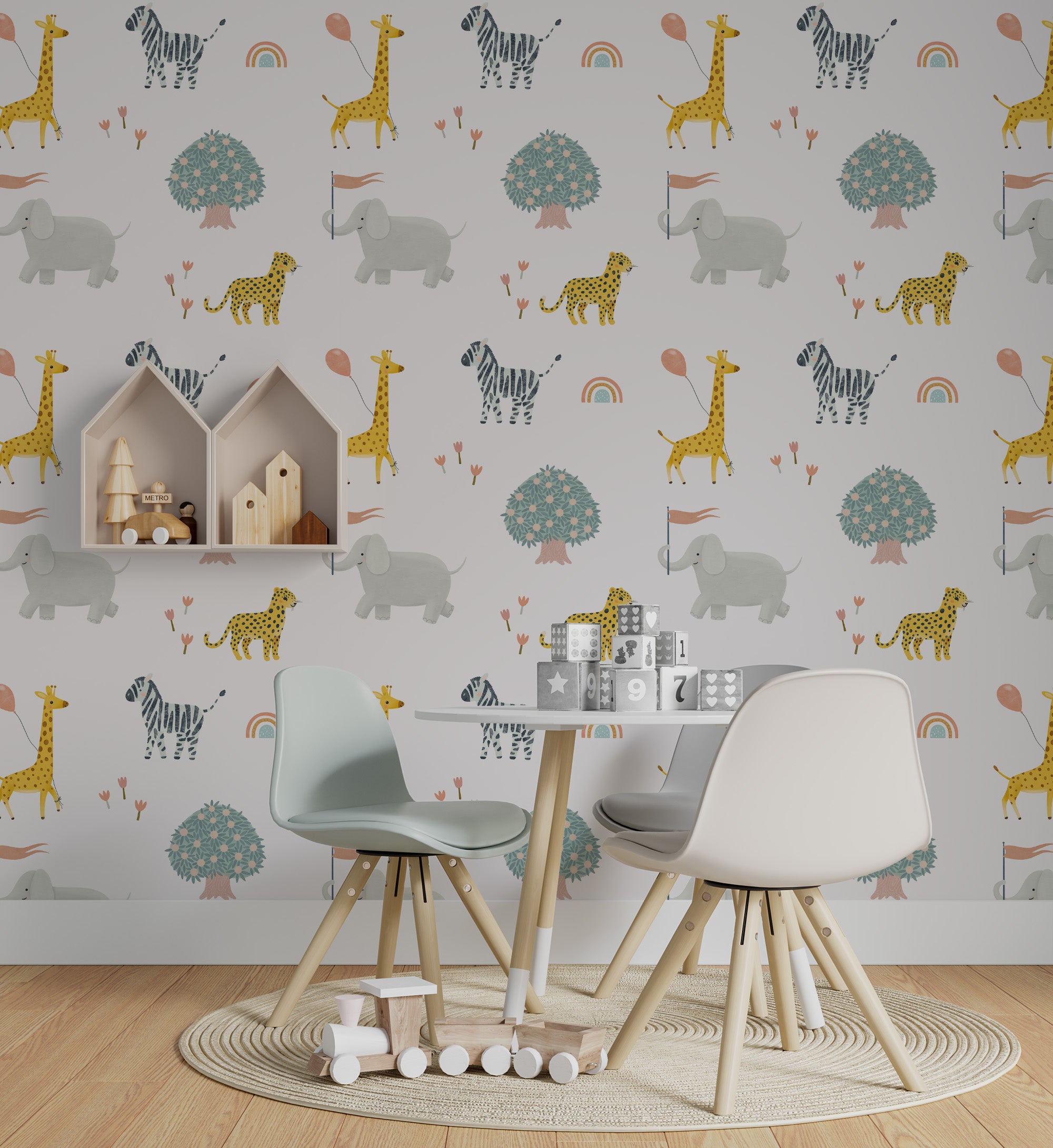 A children's playroom decorated with Safari Adventure Wallpaper showing elephants, giraffes, zebras, and cheetahs in soft colors. The room includes a small kids' table with chairs, a circular rug, and wooden toys enhancing the playful, adventurous theme.