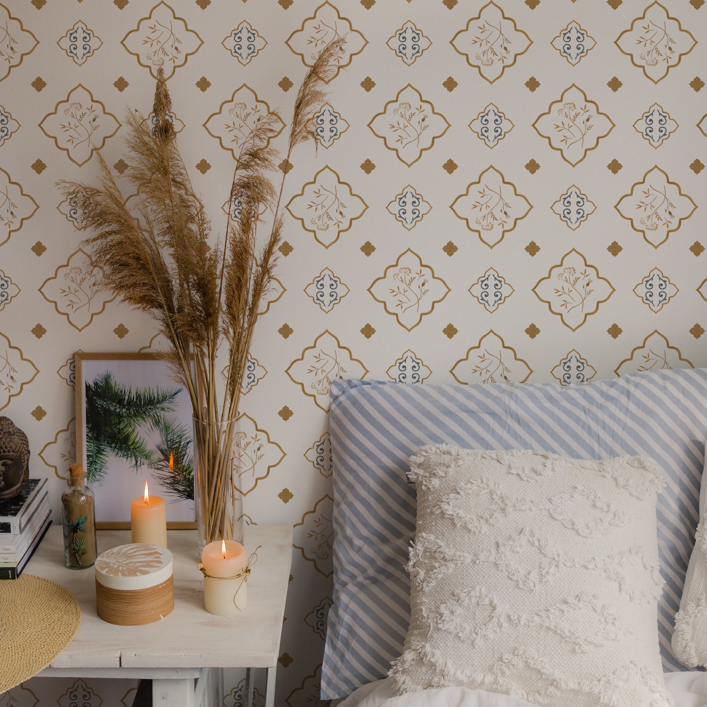 Stylish interior corner decorated with Moroccan Dream Wallpaper, highlighting a comfortable seating area with a striped couch, adorned with candles and a decorative pillow