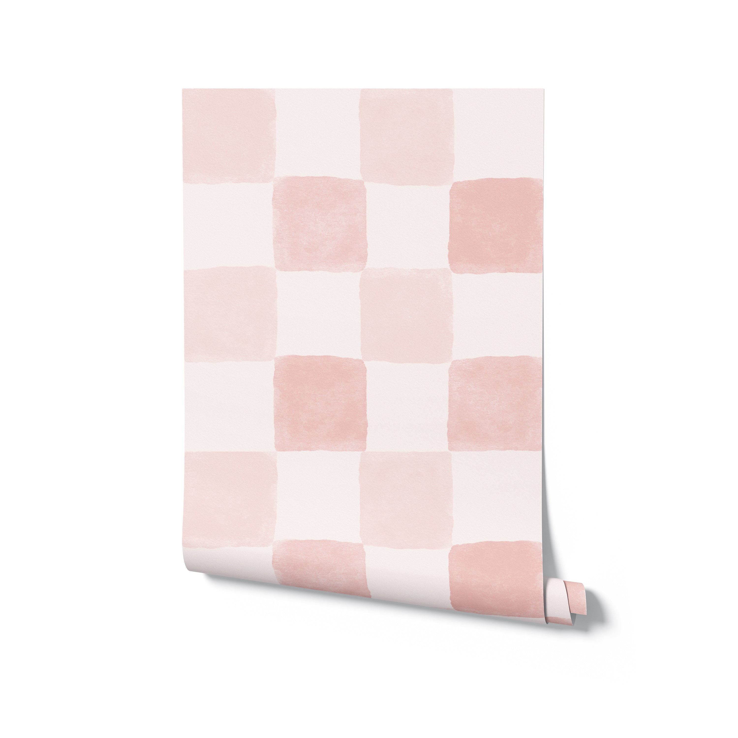 A rolled-out segment of the Clémence Wallpaper in Dusty Pink, displaying the soft watercolor checkered pattern of dusty pink and white squares, perfect for adding a gentle touch of color to modern interiors.