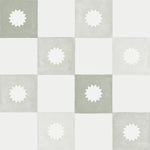 Close-up of the olive and white checkered wallpaper with a white floral emblem on each olive square. The soft, watercolor texture of the wallpaper adds a serene and natural aesthetic.