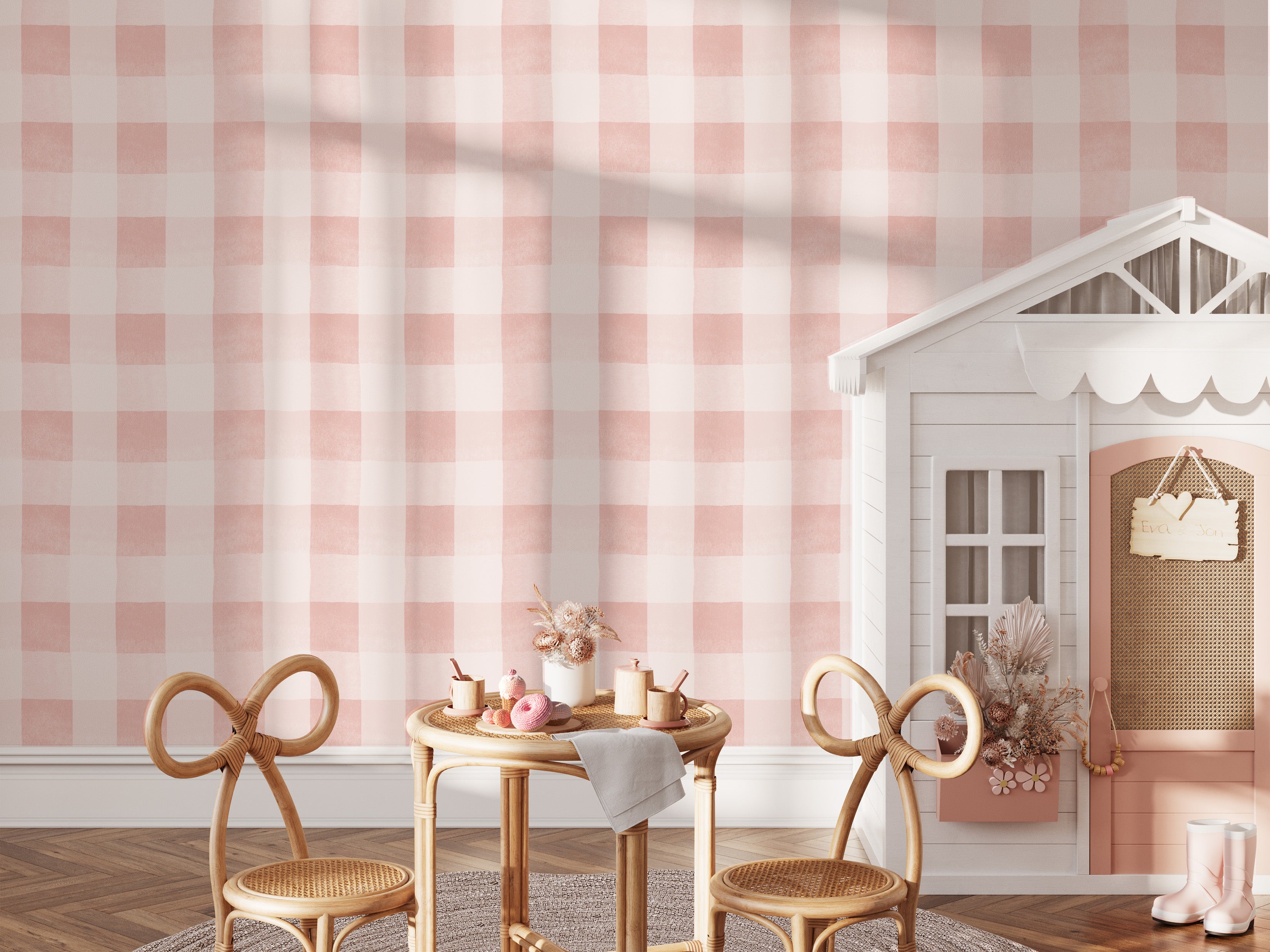 A stylish children's play area adorned with Camille Wallpaper in dusty pink. The gentle checkered pattern creates a playful yet sophisticated backdrop for the whimsical child-sized furniture and decor, enhancing the room's charming and inviting atmosphere