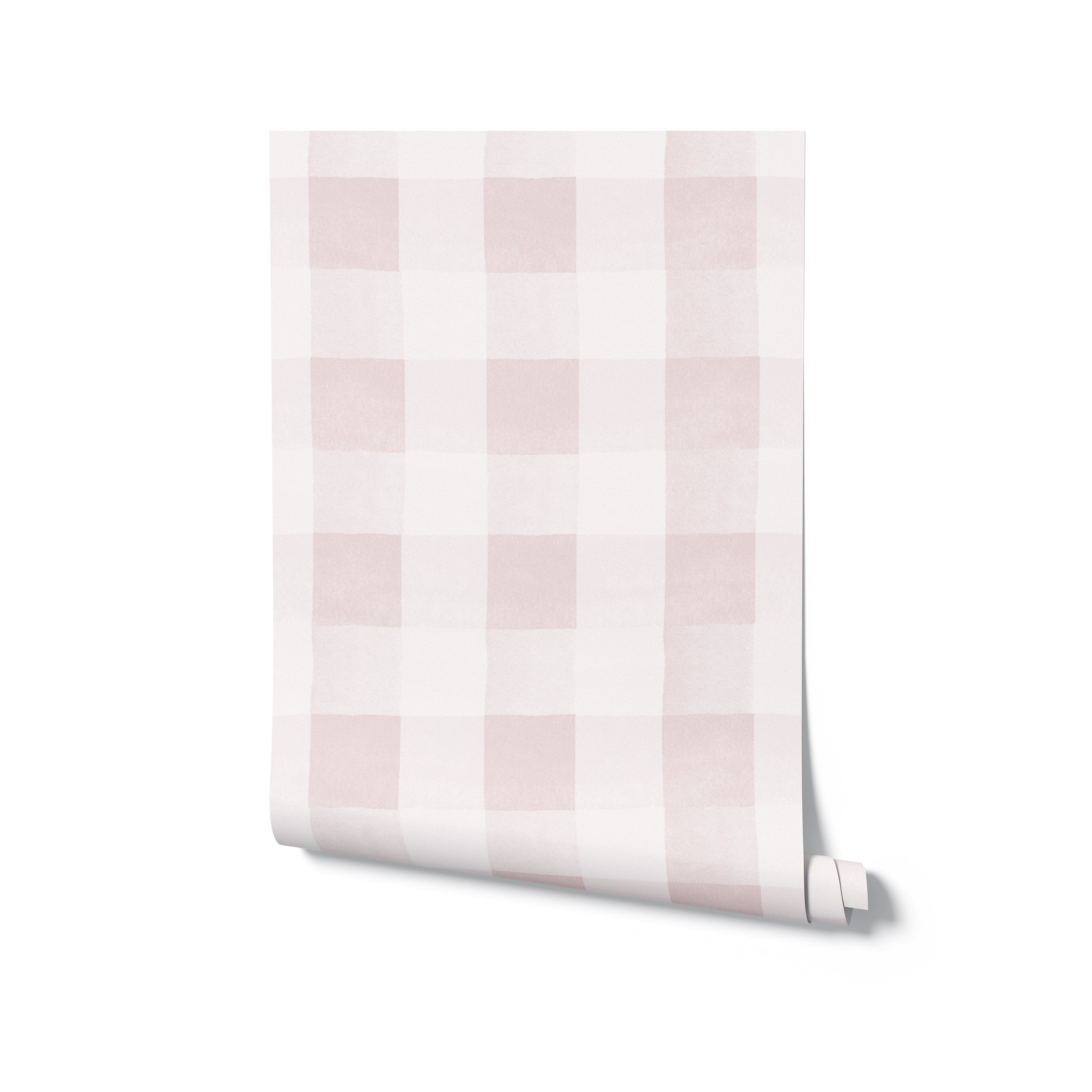A roll of Camille Wallpaper - Nude partially unrolled to reveal its elegant checkered pattern in pale pink and white. This image highlights the wallpaper’s potential to infuse any space with a sense of softness and tranquility, ideal for bedrooms and nurseries