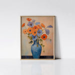 Blue Vase Blooms Art Print displayed in a gold frame against a white wall, highlighting the vivid colors and detailed brush strokes of the floral arrangement in the blue vase.