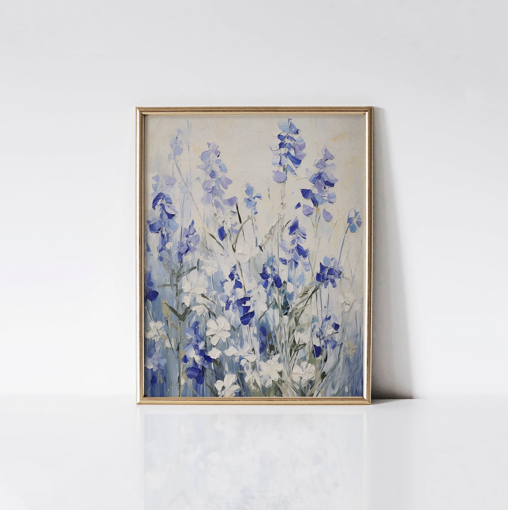 Bluebell Symphony Art Print displayed in a gold frame against a white wall, highlighting the vivid blue and white flowers and detailed brush strokes.