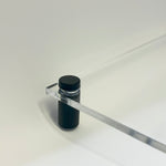 Close-up of a black cylindrical mount holding a transparent acrylic board, demonstrating the sturdy support and sleek design.
