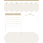 A rectangular dry erase acrylic board titled "Weekly Overview" featuring sections for each day of the week, tasks, weekly goals, and notes. The board has a soft beige and cream color scheme with rounded shapes, perfect for organizing weekly tasks and goals.
