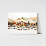 An art print displayed on a wooden board, showcasing a lively village scene with multicolored cars driving along a curvy road, surrounded by trees and mountains. The print has a playful and handcrafted feel.