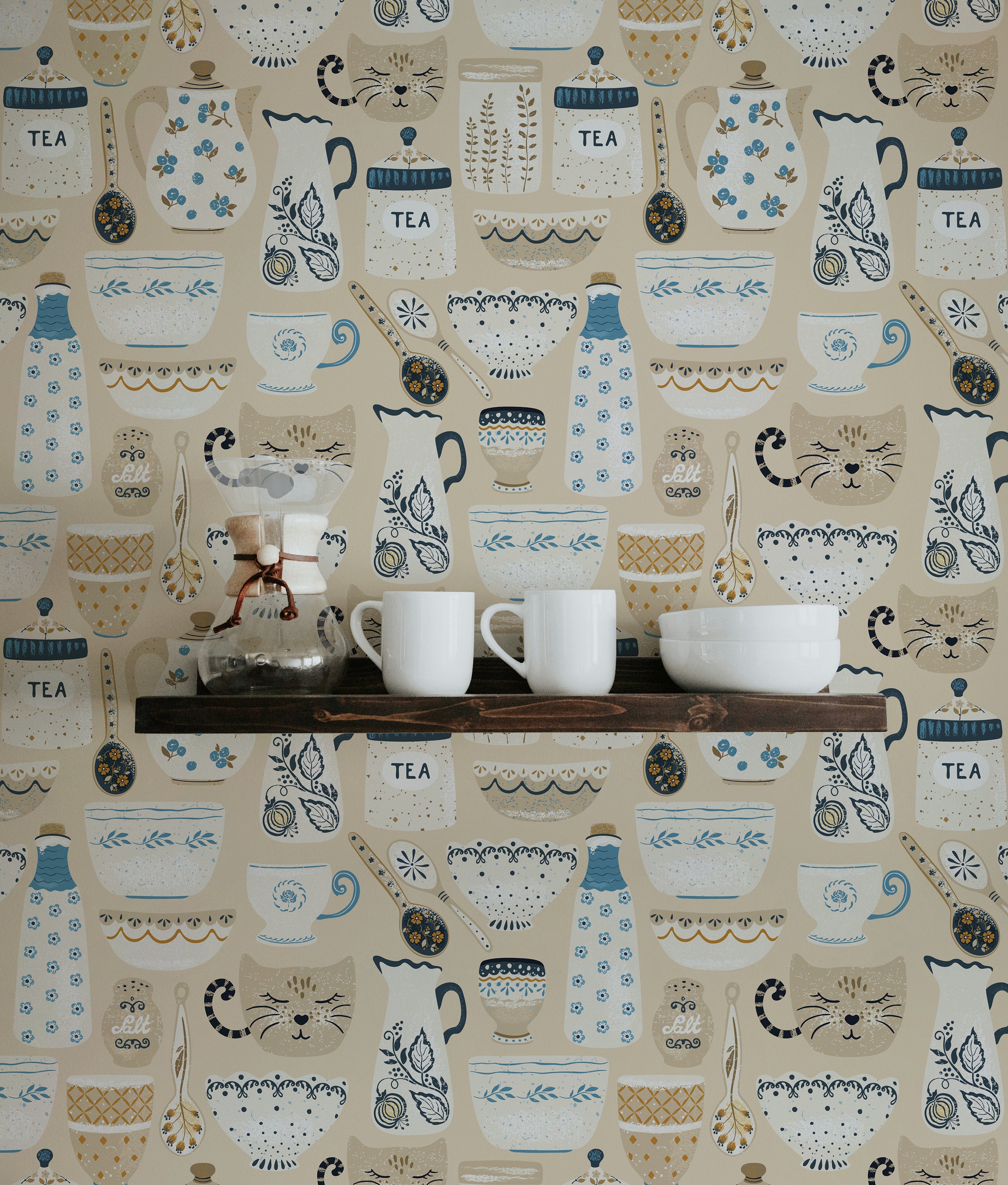 A kitchen setting featuring a wall covered in 'Spring Ceramics Wallpaper'. The wallpaper includes decorative elements like teapots, cups, and floral designs in a pastel color scheme. The scene is complemented by rustic wooden shelves displaying various kitchen items, creating a homely and inviting space.
