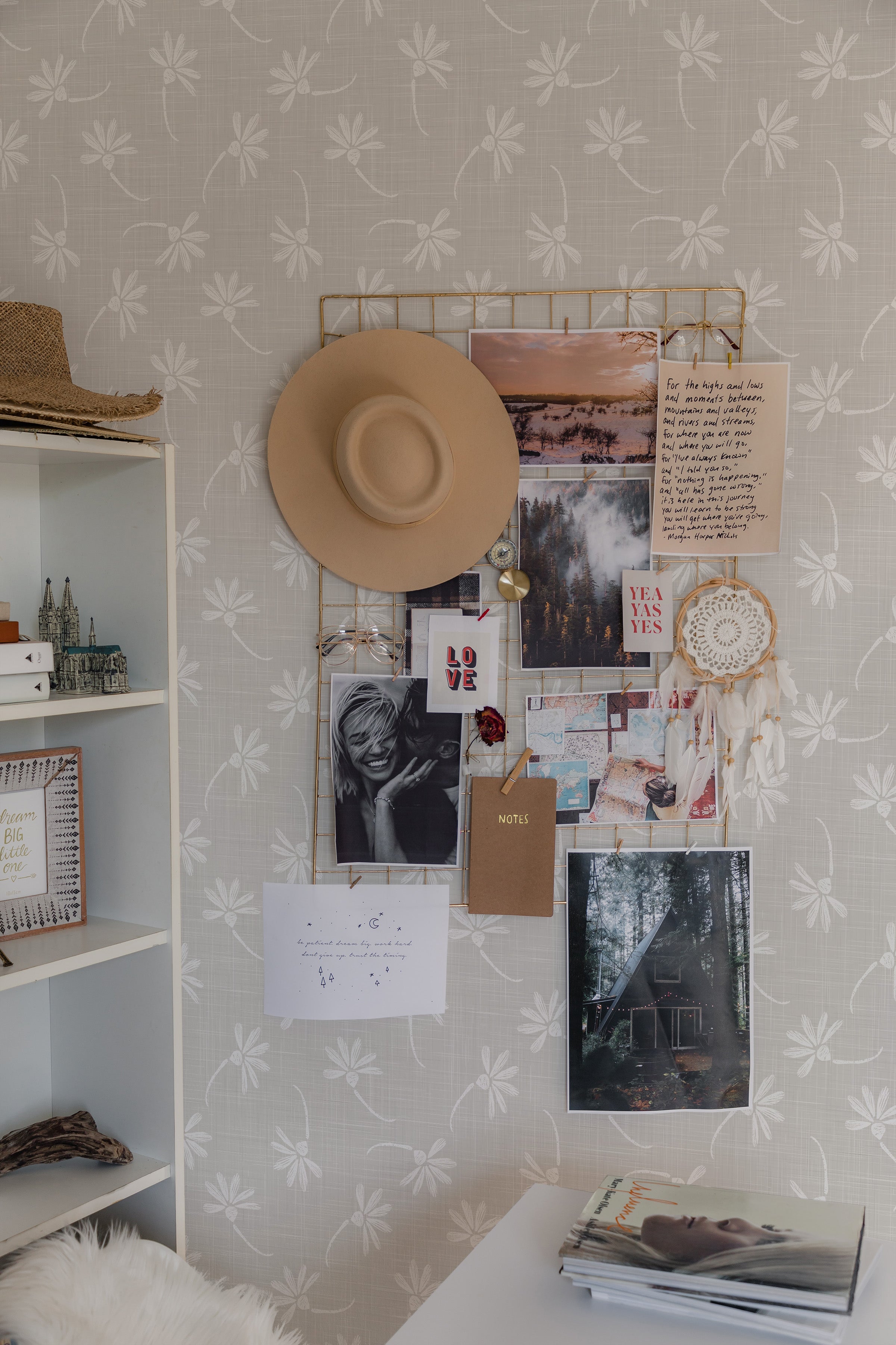 The "French Linen Floral Wallpaper" in a bedroom setting, adorned with personal photos, notes, and a dreamcatcher, creates a personalized and cozy atmosphere. The wallpaper's gentle pattern pairs beautifully with the room’s soft furnishings and rustic decor elements.