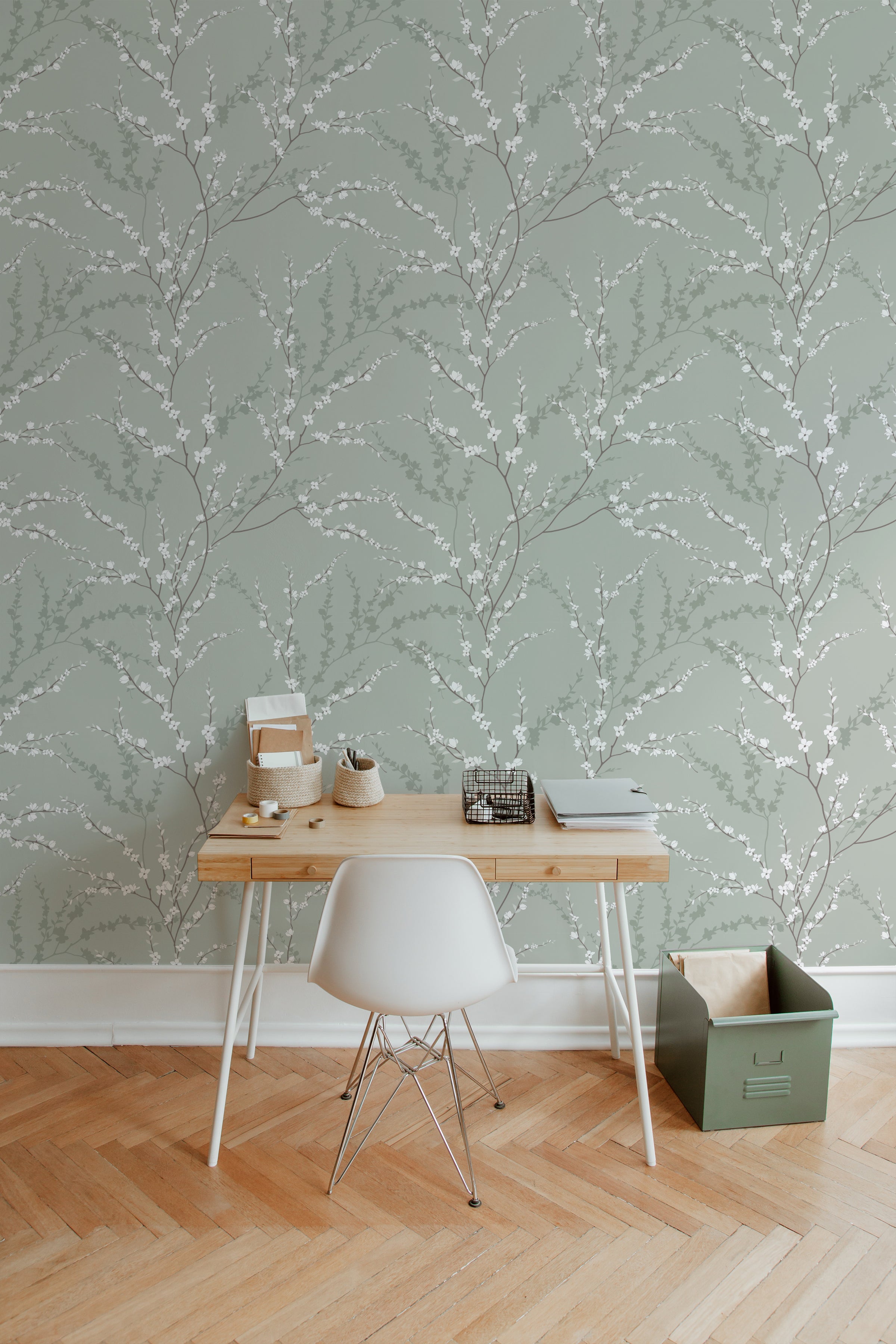 A minimalist workspace is elevated by the Enchanted Blossoms Wallpaper, which features elegant white blossoms on slender branches against a soft green background, offering a serene and sophisticated ambiance suitable for focus and creativity.