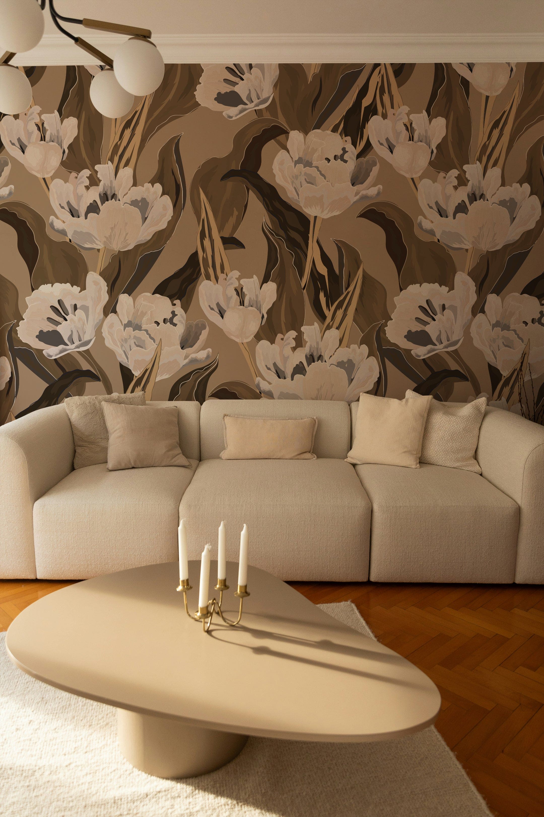 A contemporary living room showcasing the Blooming Tulips Wallpaper on a feature wall. The wallpaper, with its large white and gray tulips on a taupe background, complements the neutral-toned sofa and modern coffee table, enhancing the space with a sophisticated botanical theme.