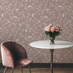 A chic corner of a room featuring the Botanical Elegance wallpaper in taupe with white floral patterns. A velvet pink chair and a round table with a vase of pink roses complement the wallpaper, adding a touch of sophistication.