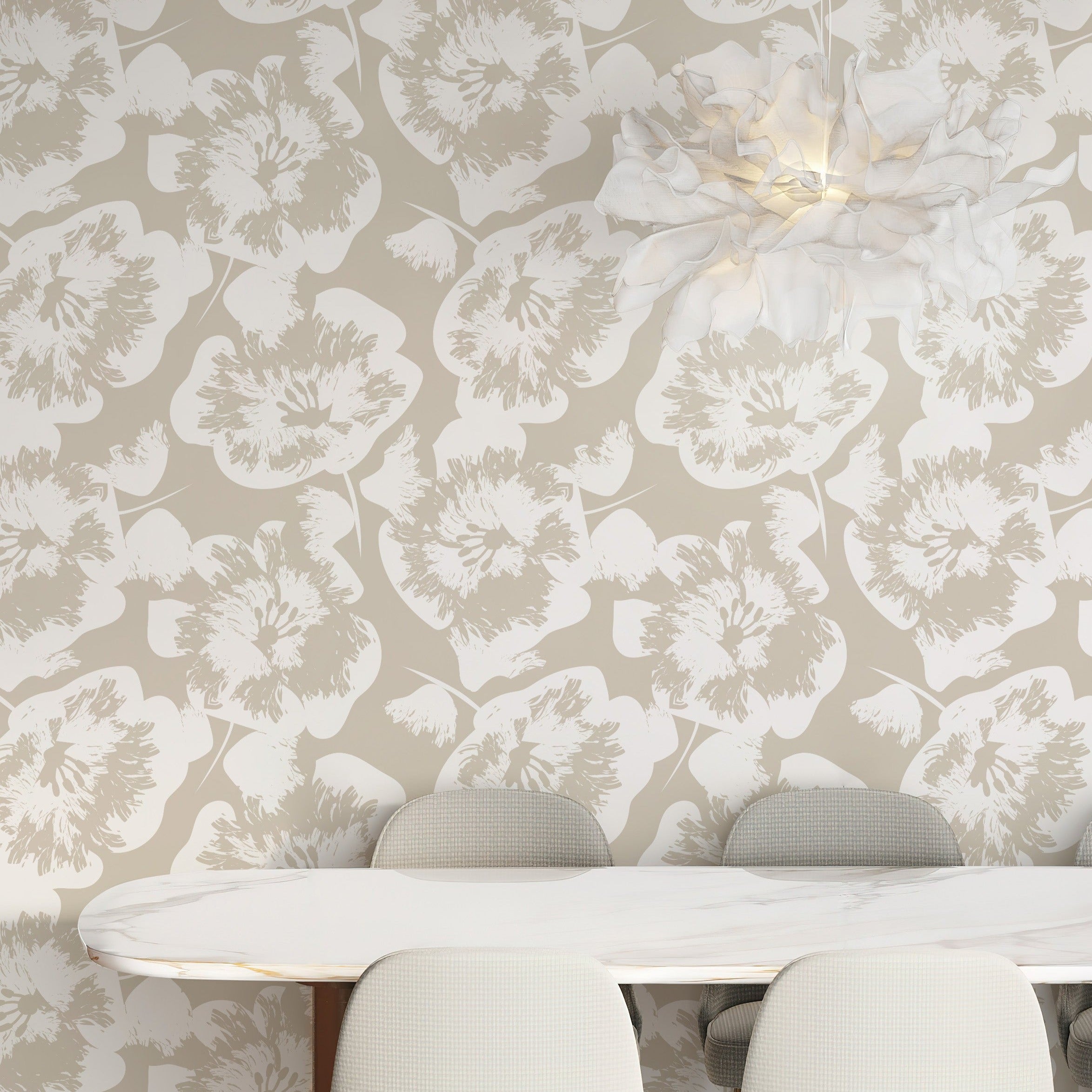 A cozy dining area adorned with Stamped Floral Wallpaper, creating an inviting ambiance with its large, hand-stamped flower motif in a soothing beige palette. The design complements the modern furniture and adds a touch of nature-inspired elegance.