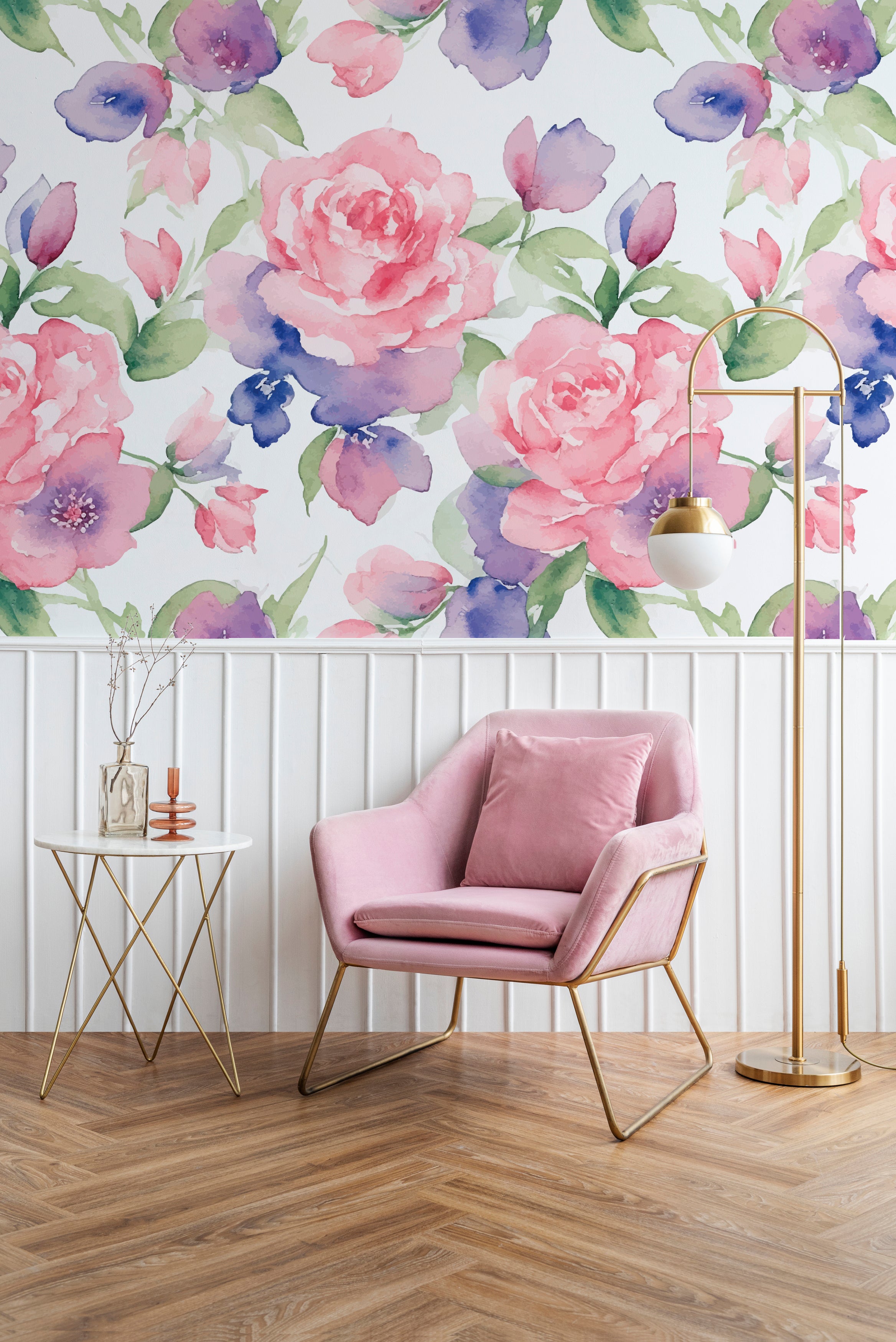An elegant living area decorated with Mystic Garden Wallpaper, featuring large pink roses and subtle blue flowers. The room includes a plush pink armchair and a gold and white side table, creating a sophisticated and calming space perfect for relaxation