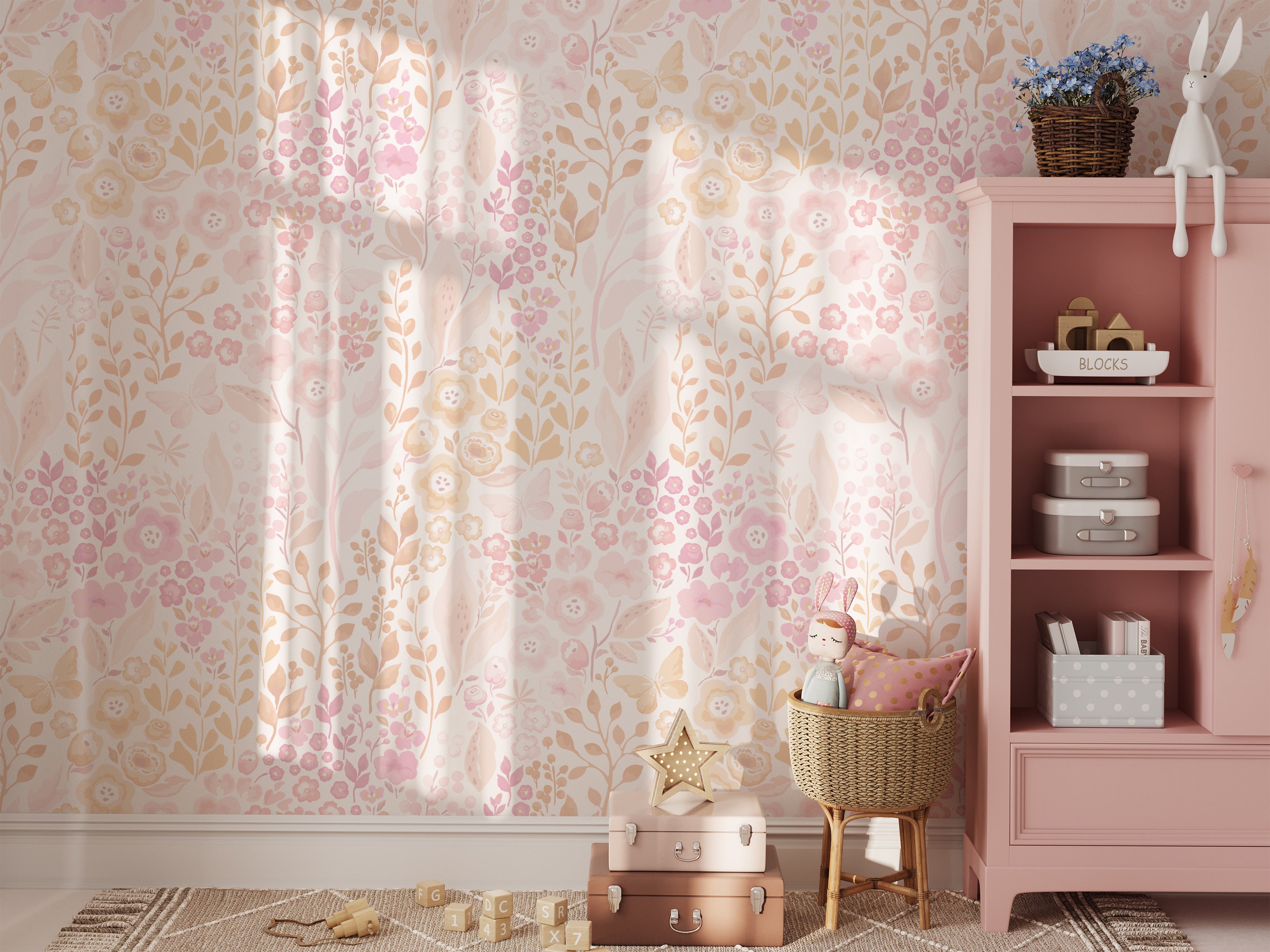 A cozy nursery corner graced with the 'Pretty Petals Wallpaper', providing a dreamy and tender setting for a child's room. The soft wallpaper pattern complements the pink shelving, plush toys, and star-shaped decor, creating a whimsical space for little ones.