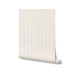 Roll of wallpaper with thin blue stripes on a white background