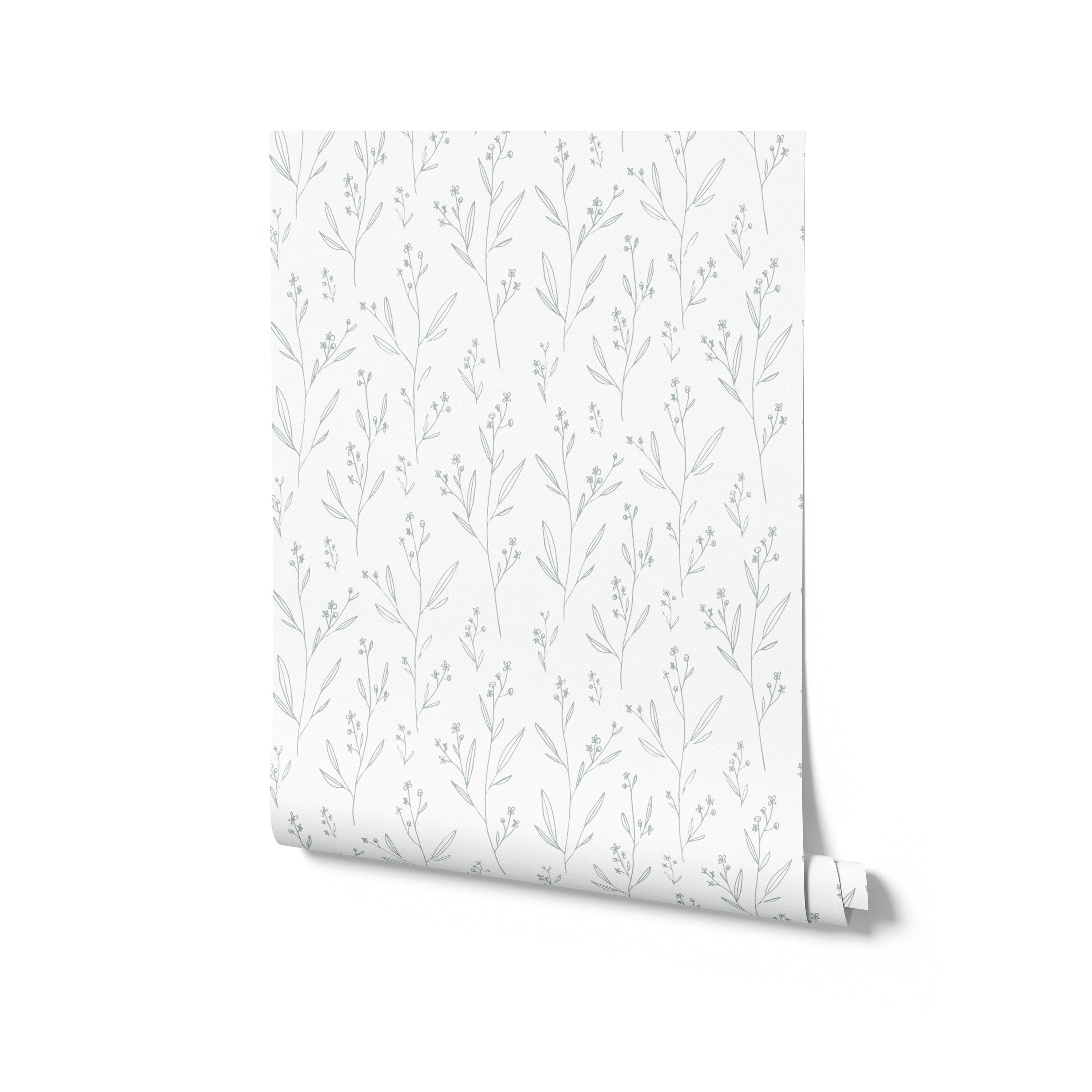 A rolled sample of the Dainty Minimal Floral - Light Sage wallpaper, highlighting the light and airy botanical design. The wallpaper presents a series of slender branches with delicate leaves and flowers, all rendered in a light sage green that suggests a fresh, spring-like ambiance. This image indicates the wallpaper’s potential to bring a touch of nature’s tranquility into a home.
