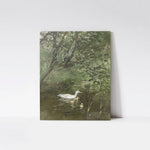 A vintage art print titled 'Ducks in Water,' displayed on a minimalist wood board mockup. The artwork features a serene scene of a duck with her ducklings swimming in a tranquil pond, surrounded by lush greenery and overhanging branches.