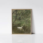 A vintage art print titled 'Ducks in Water,' displayed in a sophisticated gold frame. The artwork captures a tranquil scene of a duck with her ducklings swimming in a serene pond, surrounded by lush greenery and tree branches, with the gold frame adding an elegant touch