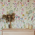 Detailed view of Hera's Floral Wallpaper illustrating a lush meadow of hand-painted style florals in hues of pink, purple, and green, offering a vibrant and artistic touch to any room's decor.