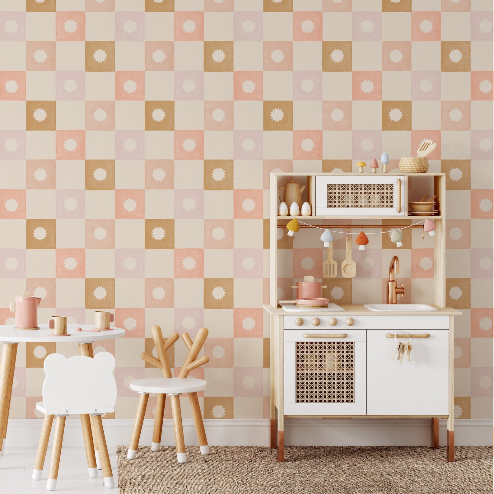 Children’s play area decorated with Coralie Wallpaper, featuring pastel-toned squares and sunburst patterns. The space is furnished with a small wooden play kitchen and child-sized furniture, making it bright and cheerful.