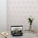 A home office setup with Mermaid Sea Shell wallpaper creating a calm and inviting workspace. The desk features a laptop, notebooks, and a vase of fresh flowers, enhancing productivity in a stylish environment