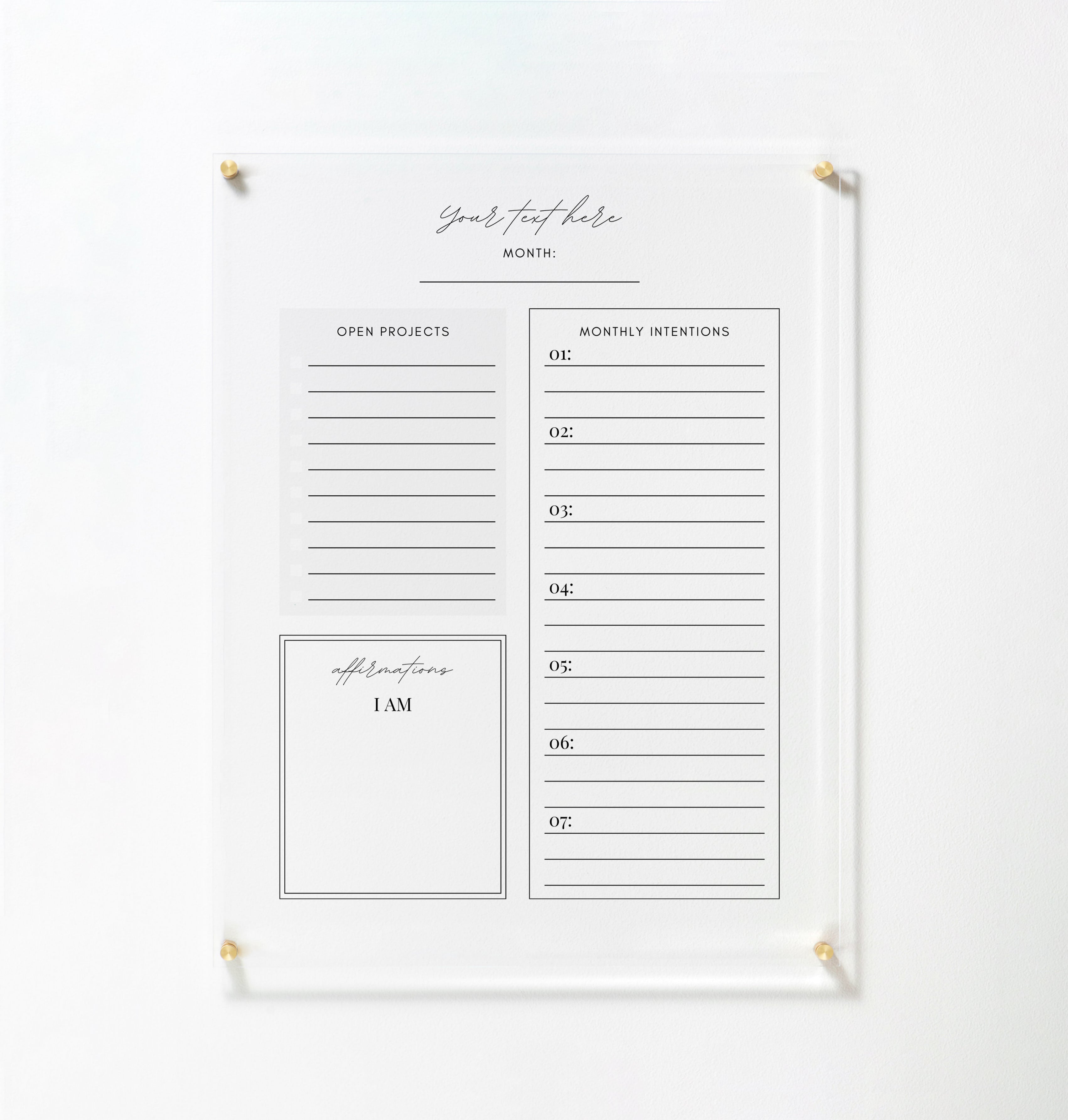 The full view of the same acrylic board, mounted on a white wall with gold pins. The board includes sections for open projects, monthly intentions, and affirmations, offering a structured layout for organizing tasks and setting intentions.