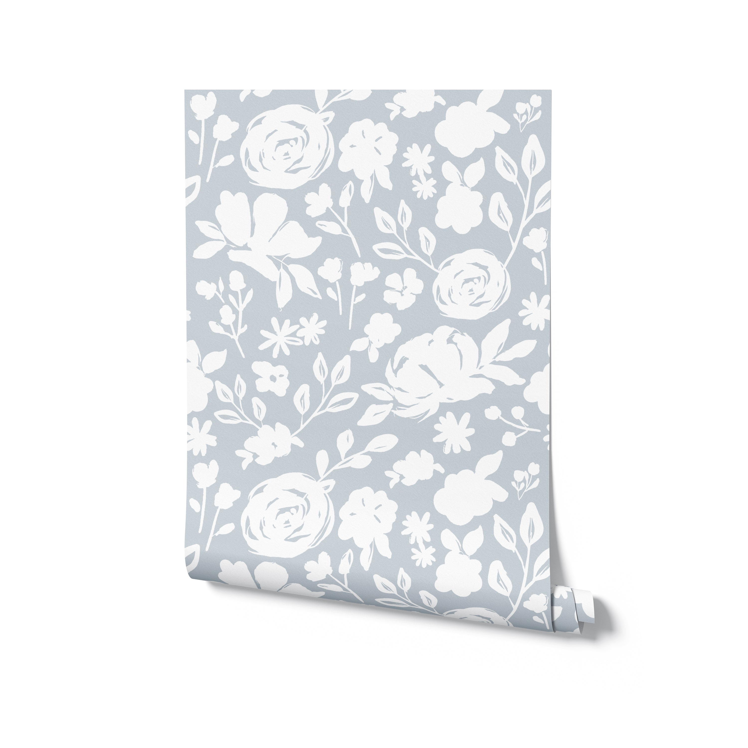 Roll of pale blue floral silhouette wallpaper, slightly unrolled to display the intricate white floral patterns on a soft blue background. This wallpaper offers a refined and airy feel, ideal for creating a light and inviting space in any home.