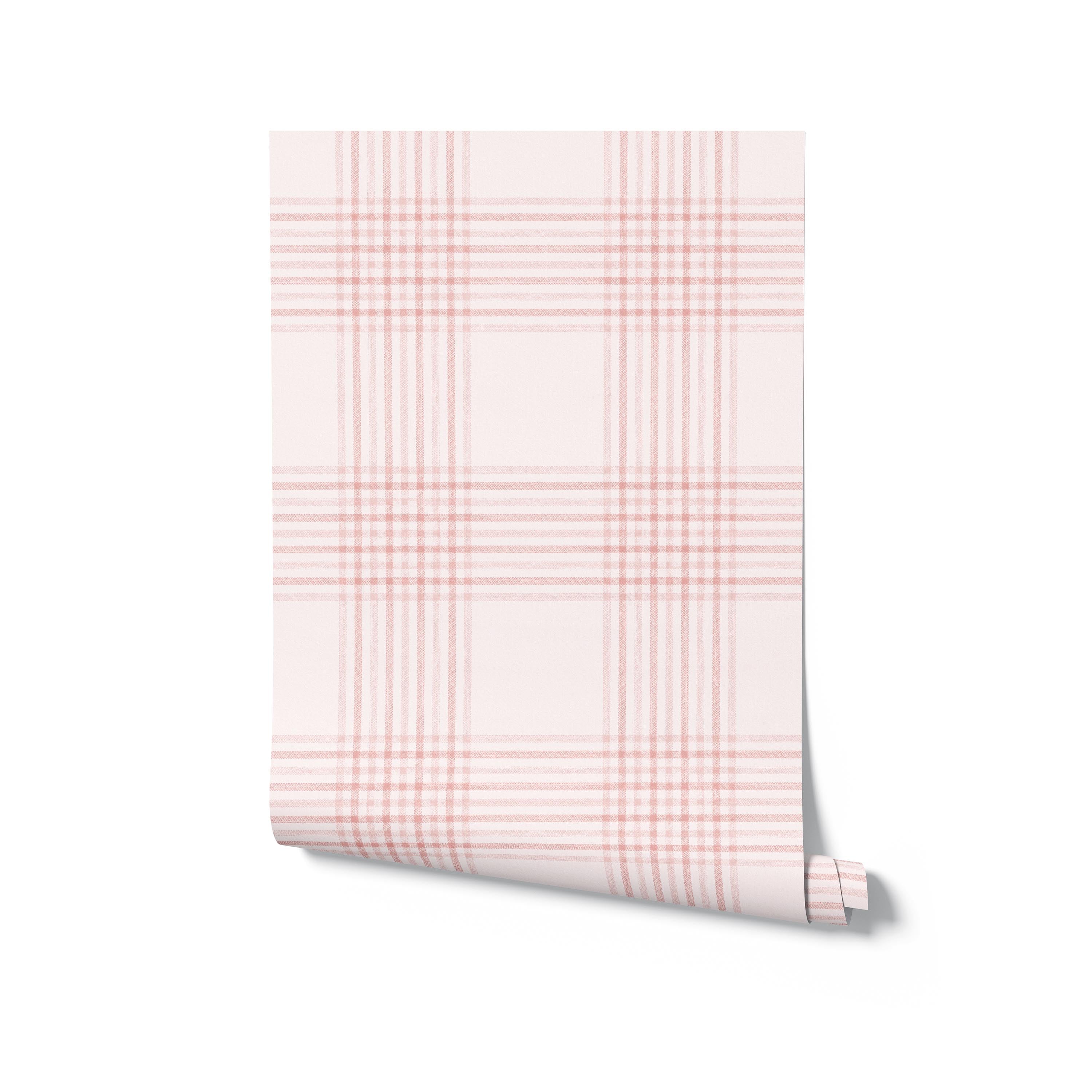 A roll of pink plaid wallpaper unrolled to display the full pattern. The design features a delicate checkered pattern in soft pink hues with intersecting lines. The classic plaid look is ideal for adding a touch of warmth and charm to any room.