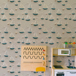 A child-focused setting with Portside Sail Wallpaper providing a joyful backdrop to a room featuring a wooden play kitchen. The wallpaper’s nautical theme is perfect for stimulating imaginative play.