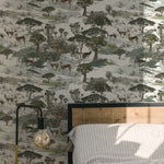 A bedroom showcasing the Serengeti Wallpaper as a feature wall behind a modern bed. The wallpaper’s intricate pattern of African wildlife and flora adds a dynamic and naturalistic element to the room, complemented by a simple bed frame and soft bedding