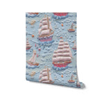 Close-up view of Breezy Sail Wallpaper, highlighting the detailed texture and colorful design of sailboats and fluffy clouds on a light blue background, perfect for a nautical-themed room.
