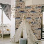 A child's playroom with Coastal Charm Wallpaper, creating a delightful nautical scene with its array of sailboats and gentle waves, complemented by a playful tent and a cozy interior setting.