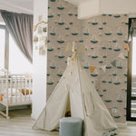 A child's play area with a tent set up against a wall covered in Portside Sail Wallpaper, which features an array of textured sailboats on a sandy beige background, evoking the calm of a seaside marina.