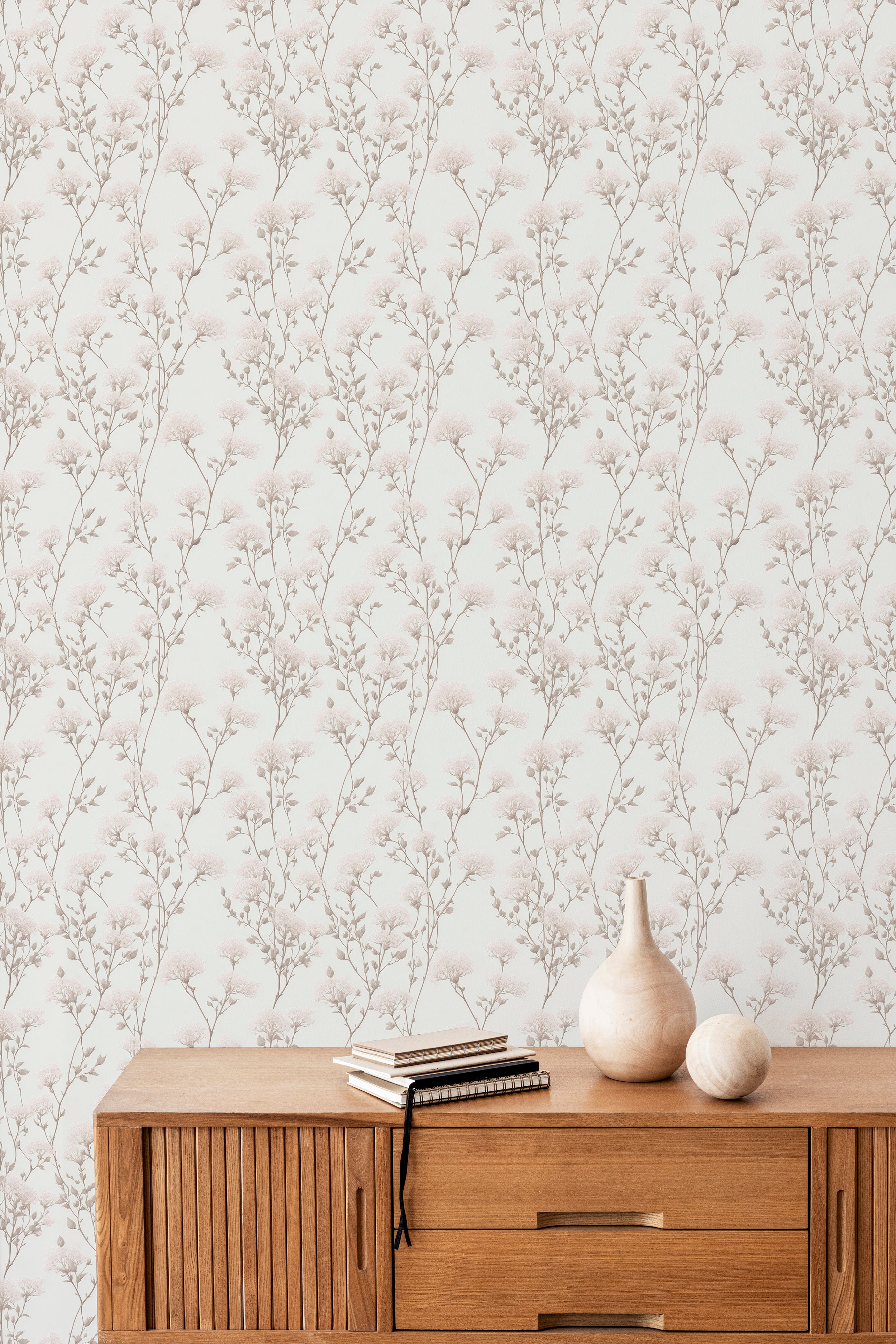 An elegant interior wall featuring the Vintage Floral Reverie Wallpaper, with intricate branches and delicate floral patterns in shades of muted pink and gray, creating a timeless, sophisticated look.