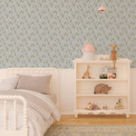 Interior view of a child's bedroom with Simple Floral Wallpaper - 12.5" on the feature wall. The wallpaper displays a charming pattern of small white flowers and green foliage on a soft blue background, enhancing the room's cozy and playful decor.