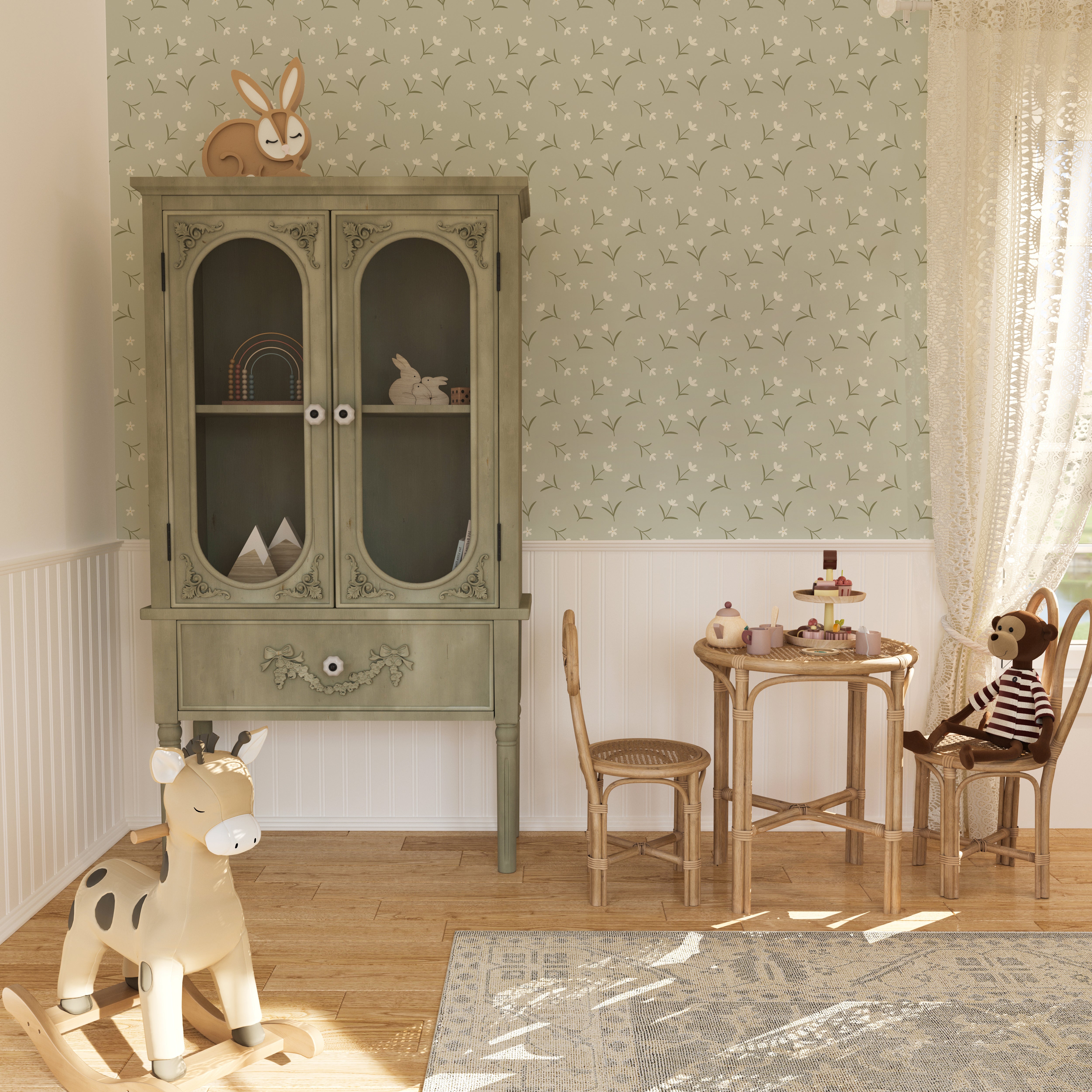 Interior view of a charming children's room with Soft Meadow Wallpaper - 12.5" on the feature wall. The wallpaper features a delicate pattern of small white flowers and green leaves on a soft sage background, creating a whimsical and inviting atmosphere.