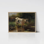 A vintage art print titled 'Spotted Cow,' featuring a black-and-white cow standing near a pond, framed in light wood. The lush greenery and soft lighting enhance the tranquil, pastoral atmosphere. The light wood frame adds a modern touch to the artwork.