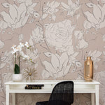 A serene workspace enhanced by the Floral Beauty Wallpaper, featuring elegant floral designs in soft white on a taupe background. A minimalist desk with a white orchid, golden decorative items, and black chair complements the wallpaper’s elegant aesthetics.