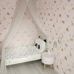 a charming children's bedroom adorned with Safari Animal Wallpaper. This sweet and playful pattern features an array of safari animals such as giraffes, lions, elephants, and zebras in soft brown tones on a pink background. The room is furnished with a white canopy bed with a panda-themed bedding set, and the wall is decorated with whimsical shelves holding toys and educational materials, creating a delightful and imaginative space for a child.
